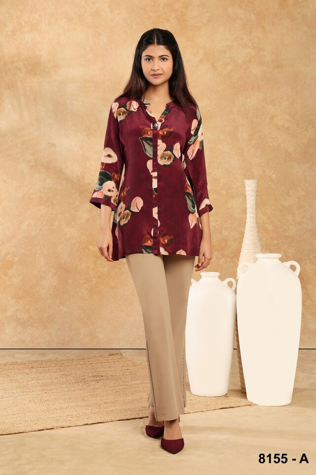 Maroon printed shirt worn with tapered beige trousers and burgundy heels