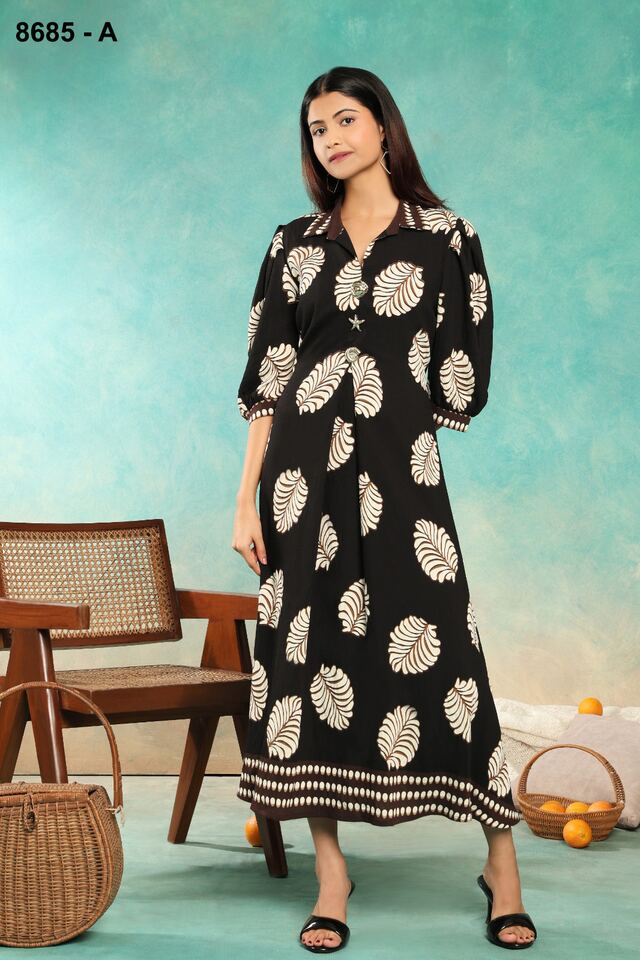 Black maxi dress with large ivory medallion prints and a bordered hem