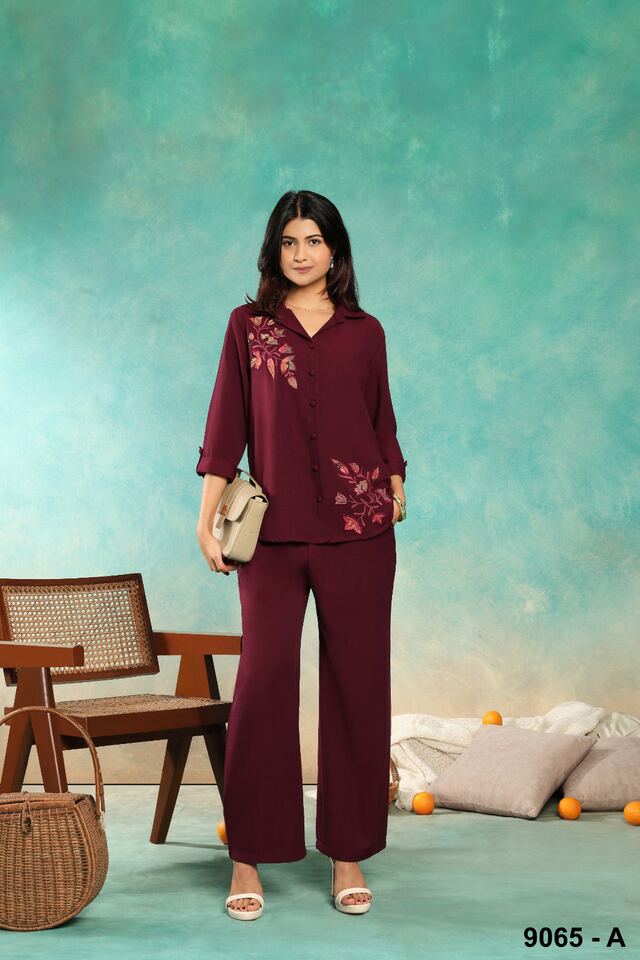 Wine co-ord set with tonal floral embroidery, carried with a beige handbag