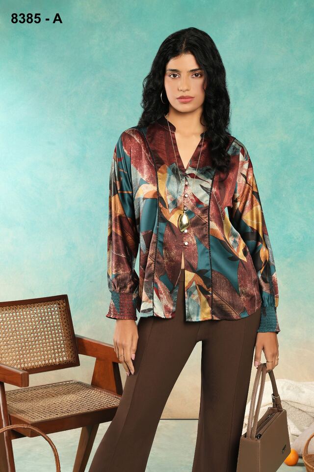 Jewel-toned abstract satin shirt with chocolate trousers and a leather handbag