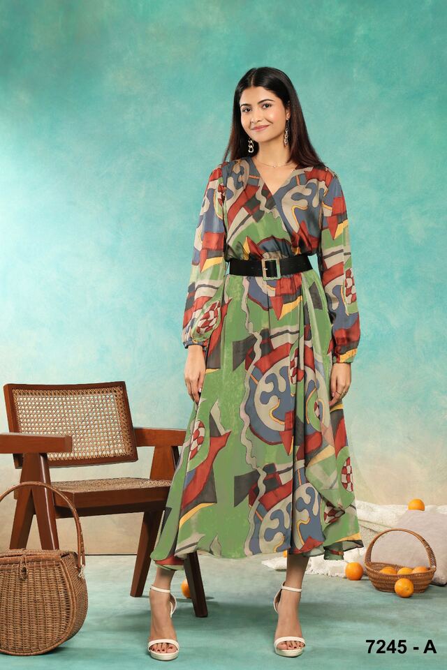 Abstract green and coral print wrap dress cinched with a black belt