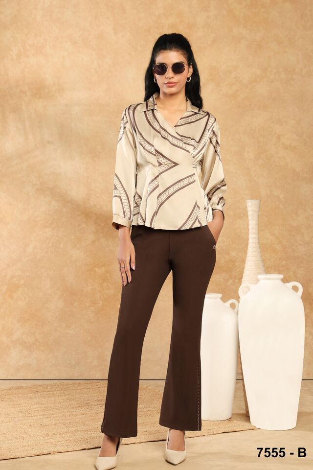 Ivory shirt with sweeping brushstroke print worn with brown flared trousers