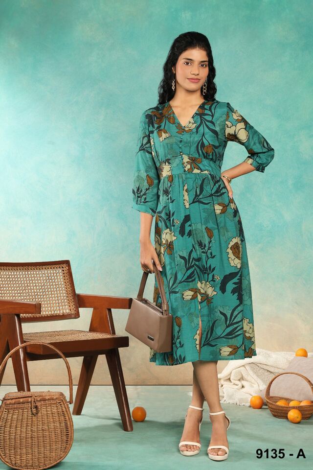 Teal floral midi dress with balloon sleeves, carried with a structured handbag